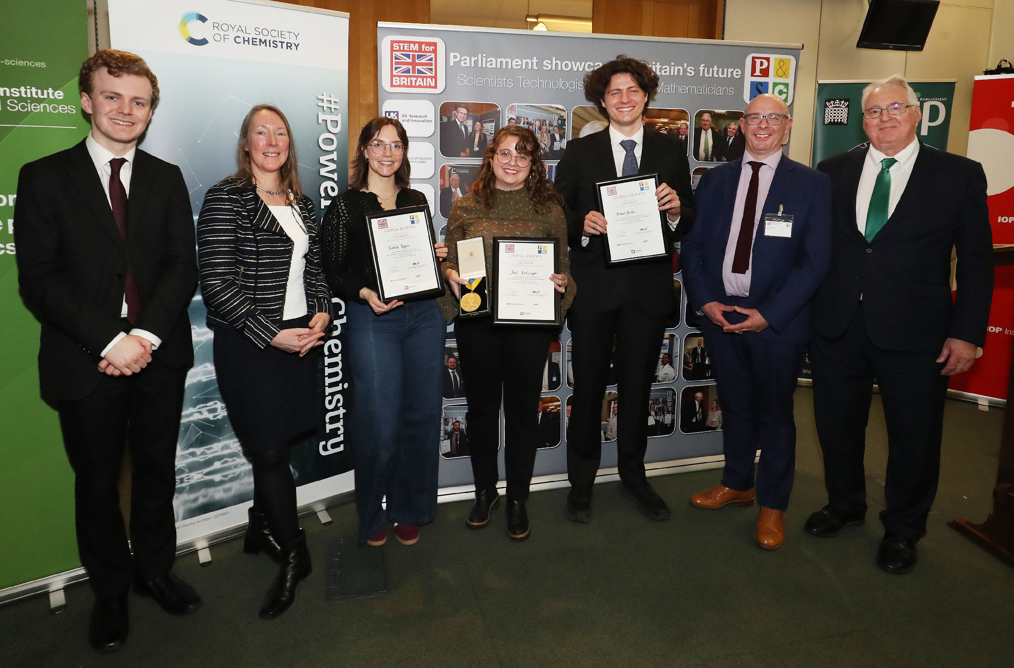 Medal winners and guests at the STEM for Britain 2026 awards, in front of the event's parliamentary banner.